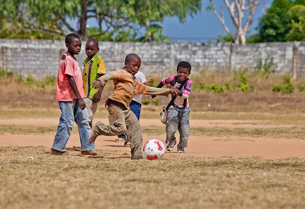 Youth playing soccer—community programs supported by our charity partners